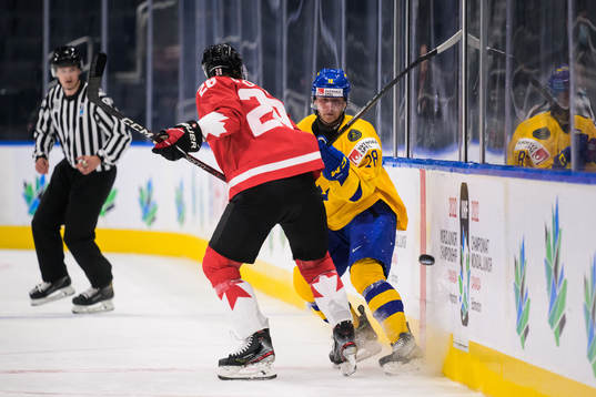 Ryan O'Rourke of Canada tackles Linus Sjödin of Sweden