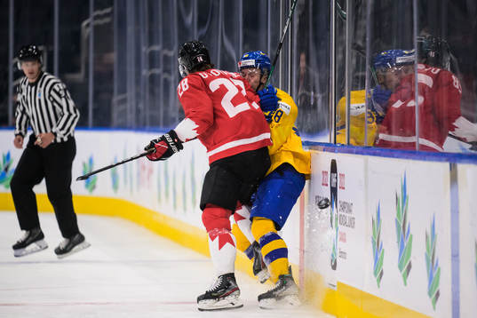 Ryan O'Rourke of Canada tackles Linus Sjödin of Sweden