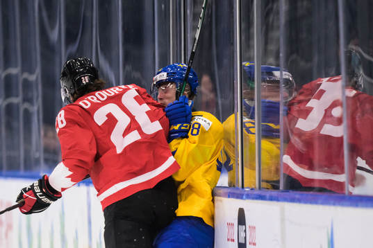 Ryan O'Rourke of Canada tackles Linus Sjödin of Sweden