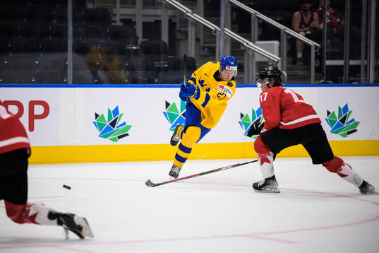 Oskar Olausson of Sweden shoots the puck