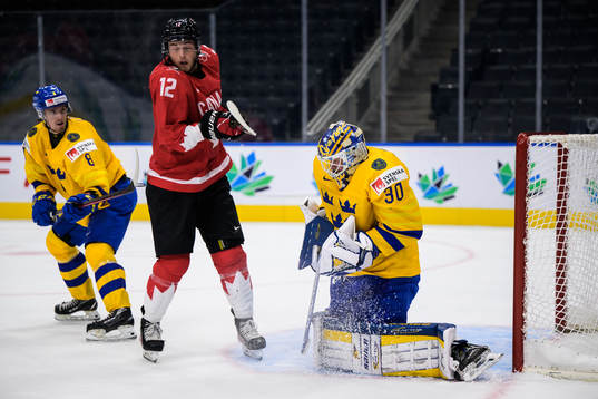 Leo Lööf and goaltender Calle Clang of Sweden in action