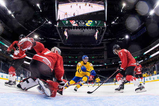 Goaltender Sebastian Cossa and Donovan Sebrango of Canada