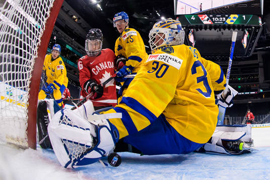 Connor Bedard of Canada challenges Åke Stakkestad and