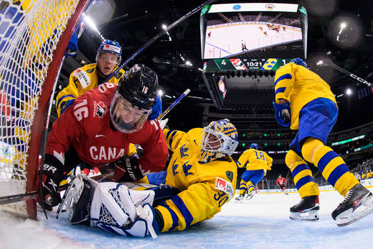 Connor Bedard of Canada challenges Åke Stakkestad and