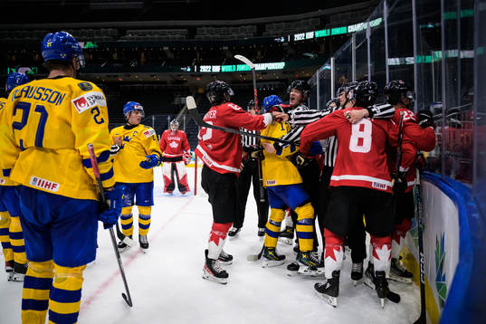 Åke Stakkestad of Sweden in a fight with Canadian players