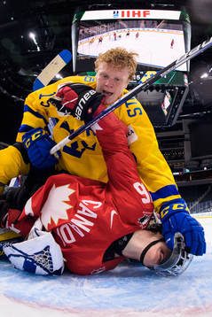 Åke Stakkestad of Sweden and Connor Bedard of Canada fight