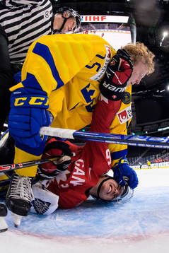 Åke Stakkestad of Sweden and Connor Bedard of Canada fight