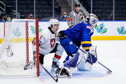 Simon Knak of Switzerland and goaltender Jesper Wallstedt