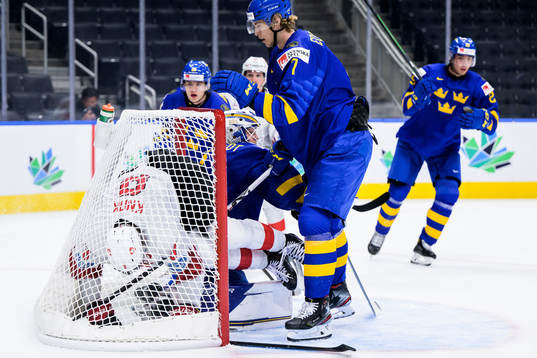 Simon Knak of Switzerland against goaltender Jesper