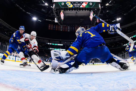 Ludvig Jansson and goaltender Jesper Wallstedt of Sweden