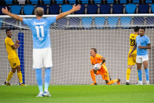 Goalkeeper Johan Dahlin and Martin Olsson of Malmö FF look