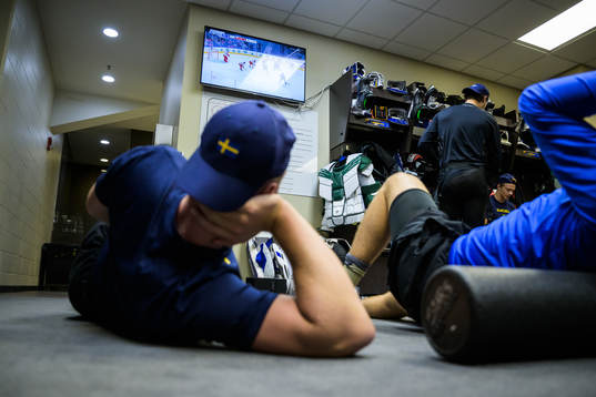 Anton Olsson of Sweden watch Finland against Czech Republic