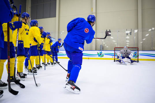 Helge Grans shoots at goaltender Jesper Wallstedt of Sweden
