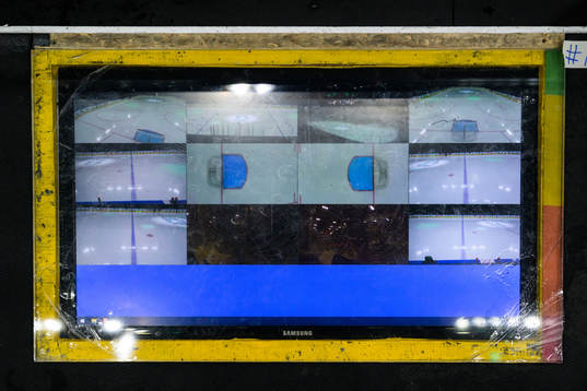 A screen showing multiple camera angles at the coaches