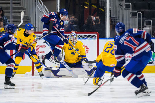 Brett Berard of USA jumps in front of goaltender Jesper