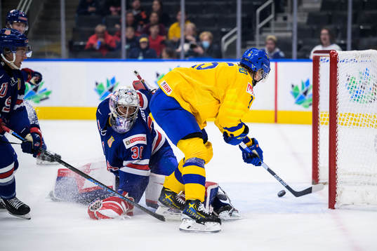 Goaltender Kaidan Mbereko of USA is being challenged by