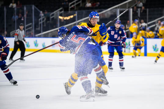 Wyatt Kaiser of USA gets tackles by Oskar Olausson of Sweden