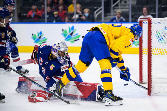 Goaltender Kaidan Mbereko of USA is being challenged by