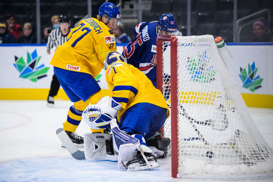 Matthew Coronato of USA scores 2-0 behind goaltender Jesper
