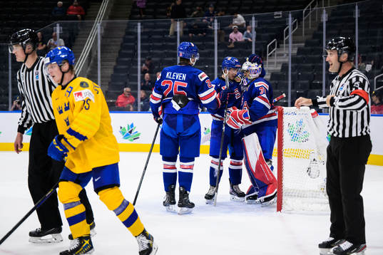 Tyler Kleven, Brock Faber and goaltender Kaidan Mbereko of
