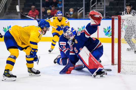 Åke Stakkestad of Sweden scores 3-2 behind goaltender