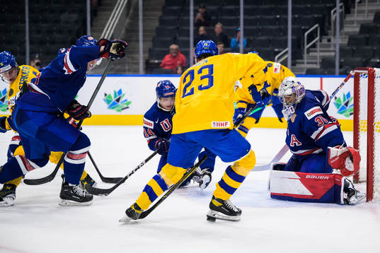 Brock Faber and goaltender Kaidan Mbereko of USA are being