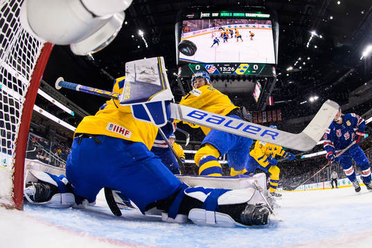 Brett Berard of USA scores 1-0 behind goaltender Jesper