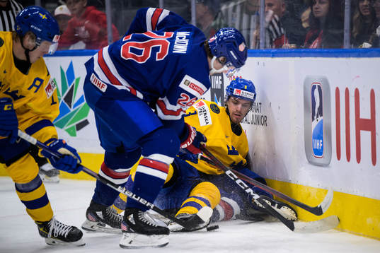 Leo Lööf of Sweden holds the puck against Hunter McKown