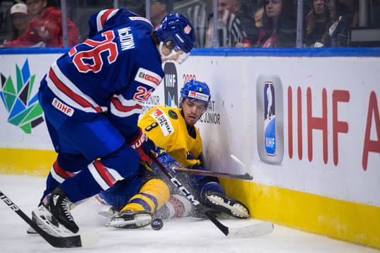 Leo Lööf of Sweden holds the puck against Hunter McKown