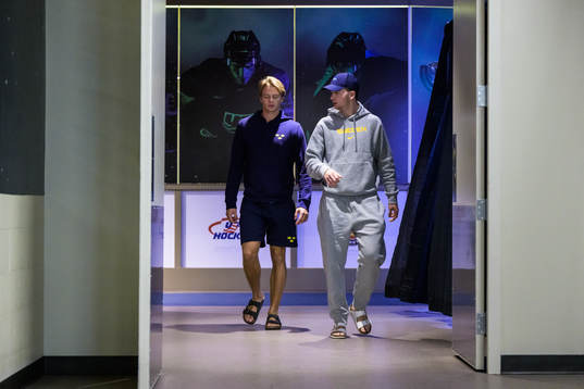 Goaltender Carl Lindbom and Isak Rosén of Sweden arrive to