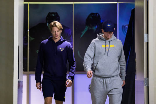 Goaltender Carl Lindbom and Isak Rosén of Sweden arrive to