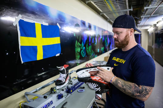 Equipment manager Andy Fagerström of Sweden sharpening