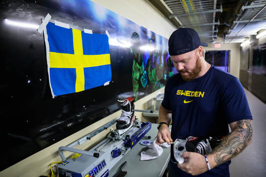 Equipment manager Andy Fagerström of Sweden sharpening