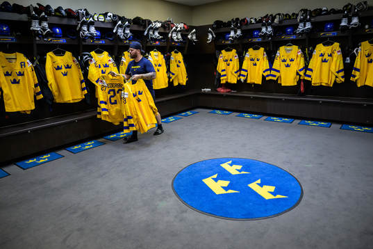 Equipment manager Andy Fagerström of Sweden hangs jerseys