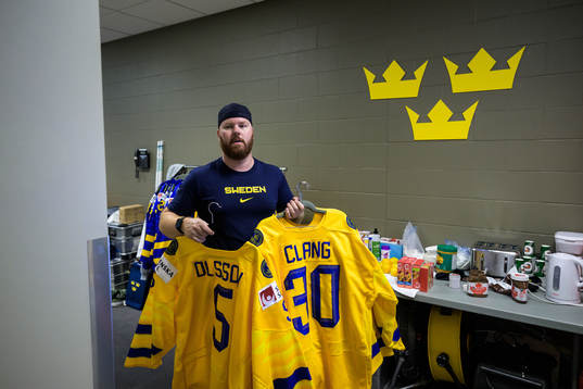Equipment manager Andy Fagerström of Sweden hangs jerseys