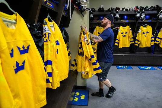Equipment manager Andy Fagerström of Sweden hangs jerseys
