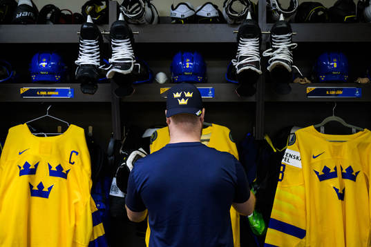 Equipment manager Andy Fagerström of Sweden hangs jerseys
