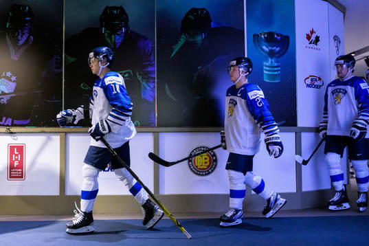 Kasper Puutio and Roni Hirvonen of Finland walk to the ice