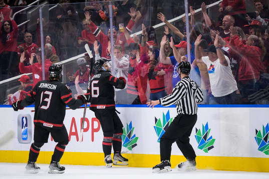 Kent Johnson and Connor Bedard of Canada celebrate the 3-0