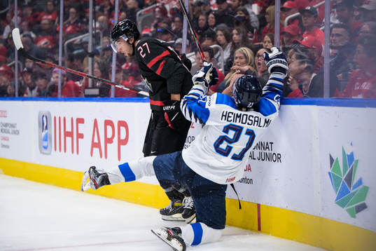 Will Cuylle of Canada tackles Aleksi Heimosalmi of Finland