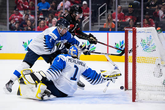 Eemil Viro and goaltender Leevi Meriläinen of Finland are