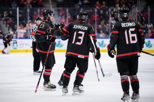 Mason McTavish of Canada celebrates with teammates