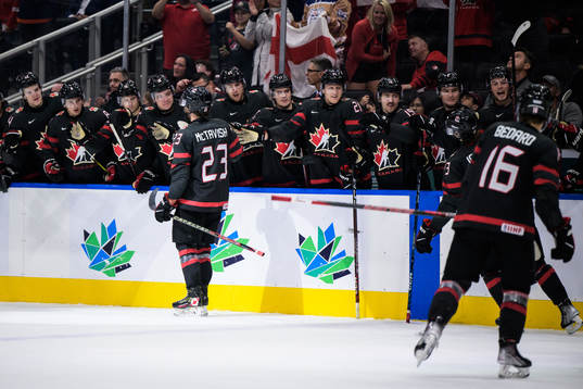 Mason McTavish of Canada celebrates with teammates