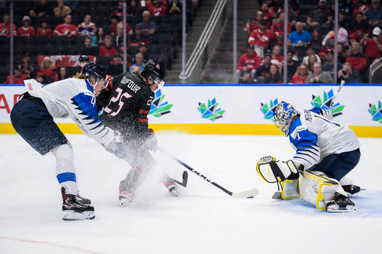 Joni Jurmo and goaltender Leevi Meriläinen of Finland are