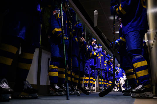 Players of Sweden wait to enter the ice for warm-up