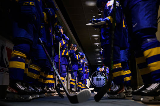 Players of Sweden wait to enter the ice for warm-up