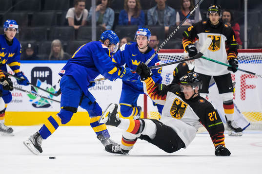 Fabian Lysell of Sweden tackles Bennet Rossmy of Germany