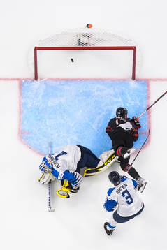 Ridly Greig of Canada scores 4-1 behind goaltender Leevi