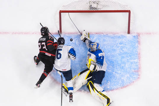 Mason McTavish of Canada challenges Eemil Viro and