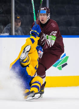 Linus Sjödin of Sweden trips in front of Sandis Vilmanis